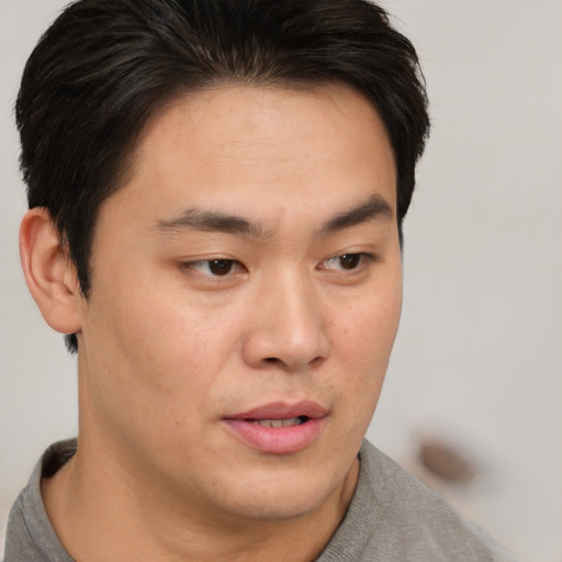 Neutral asian young-adult male with short  brown hair and brown eyes