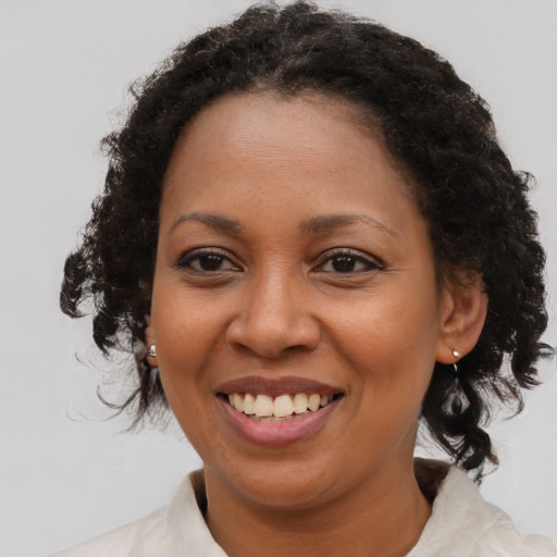 Joyful black young-adult female with medium  brown hair and brown eyes
