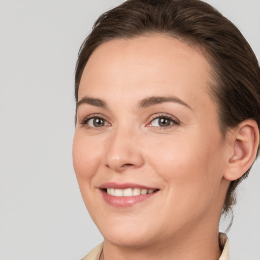 Joyful white young-adult female with medium  brown hair and brown eyes