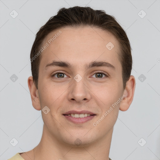 Joyful white young-adult male with short  brown hair and grey eyes