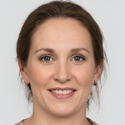 Joyful white adult female with medium  brown hair and grey eyes