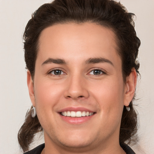 Joyful white young-adult male with medium  brown hair and brown eyes