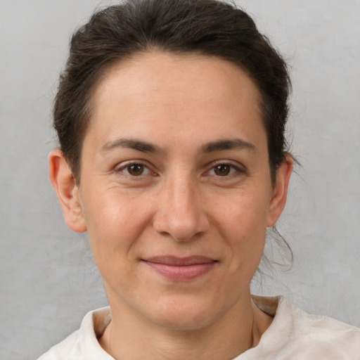 Joyful white adult female with short  brown hair and brown eyes