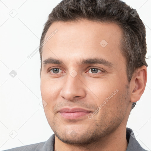 Joyful white young-adult male with short  brown hair and brown eyes