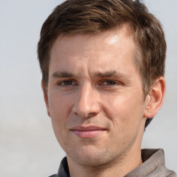 Joyful white adult male with short  brown hair and grey eyes