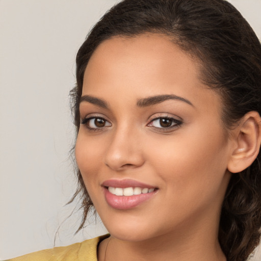 Joyful white young-adult female with long  brown hair and brown eyes