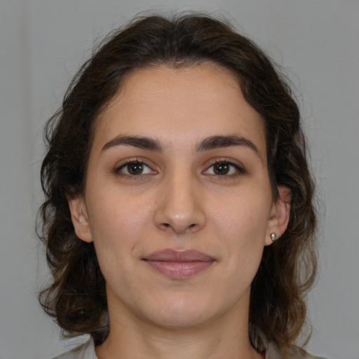 Joyful white young-adult female with medium  brown hair and brown eyes