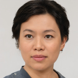 Joyful asian young-adult female with short  brown hair and brown eyes