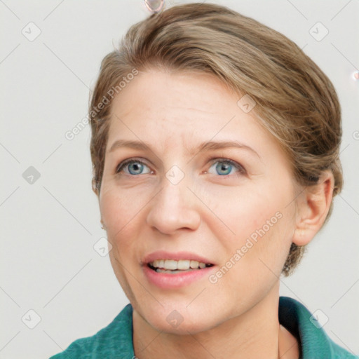 Joyful white adult female with short  brown hair and blue eyes