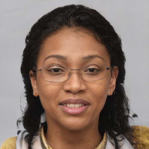 Joyful latino adult female with medium  brown hair and brown eyes