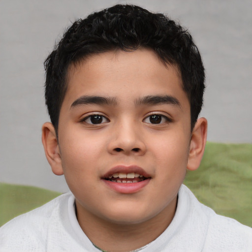 Joyful latino child male with short  brown hair and brown eyes