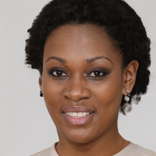 Joyful black young-adult female with short  brown hair and brown eyes