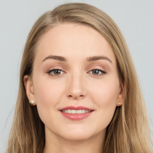 Joyful white young-adult female with long  brown hair and grey eyes