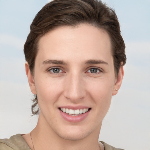 Joyful white young-adult female with short  brown hair and grey eyes