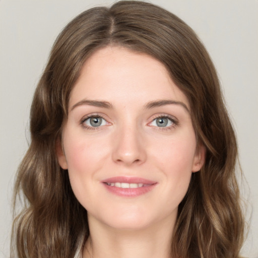 Joyful white young-adult female with medium  brown hair and green eyes