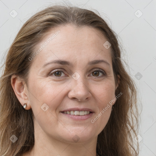 Joyful white adult female with long  brown hair and grey eyes