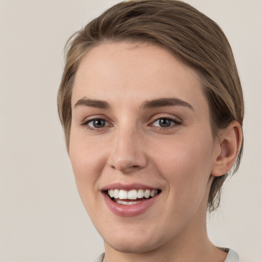 Joyful white young-adult female with medium  brown hair and grey eyes