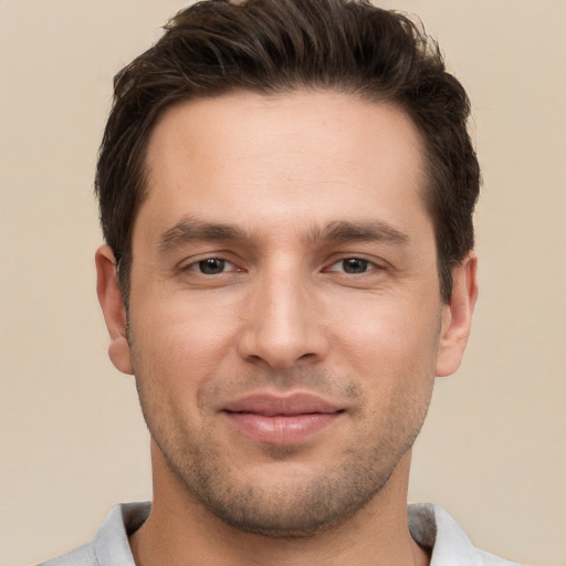 Joyful white young-adult male with short  brown hair and brown eyes