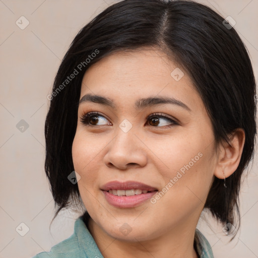 Joyful asian young-adult female with medium  black hair and brown eyes