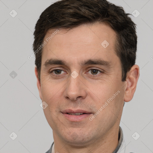 Joyful white adult male with short  brown hair and brown eyes