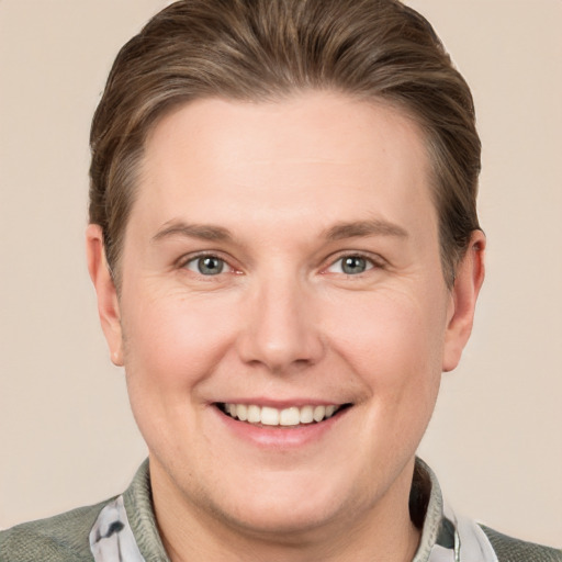 Joyful white young-adult male with short  brown hair and grey eyes