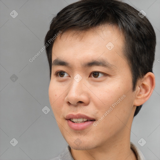 Joyful white young-adult male with short  black hair and brown eyes