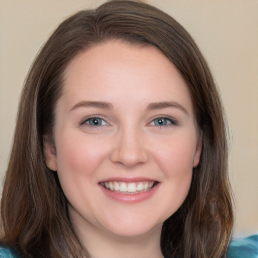 Joyful white young-adult female with long  brown hair and blue eyes