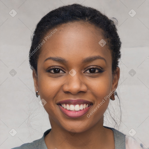 Joyful black young-adult female with short  black hair and brown eyes