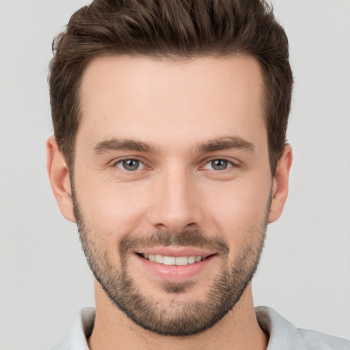 Joyful white young-adult male with short  brown hair and brown eyes