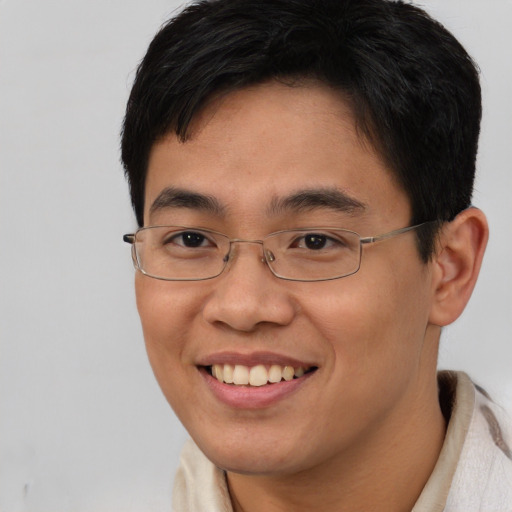 Joyful asian young-adult male with short  brown hair and brown eyes