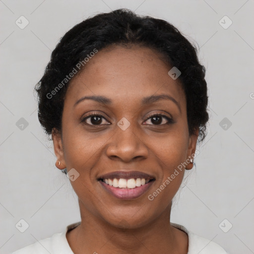 Joyful black young-adult female with short  black hair and brown eyes