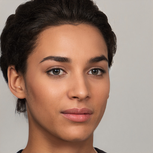 Joyful latino young-adult female with short  brown hair and brown eyes