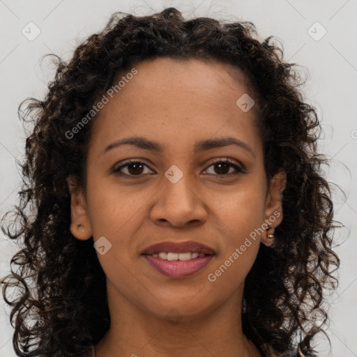 Joyful black young-adult female with long  brown hair and brown eyes