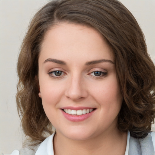 Joyful white young-adult female with medium  brown hair and green eyes