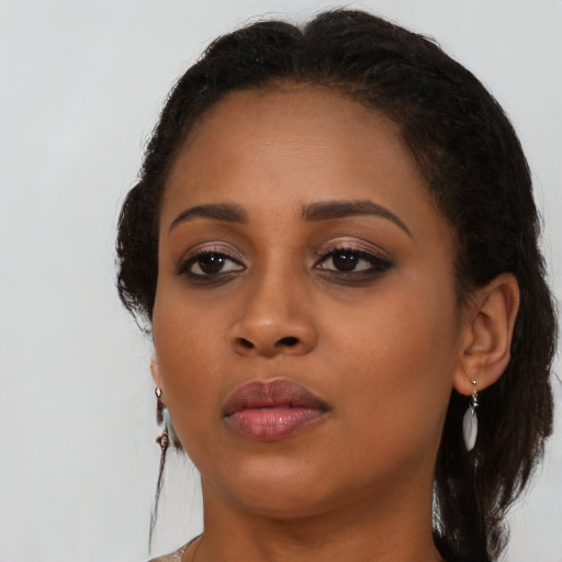 Neutral black young-adult female with medium  brown hair and brown eyes