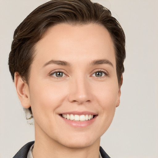 Joyful white young-adult female with short  brown hair and grey eyes