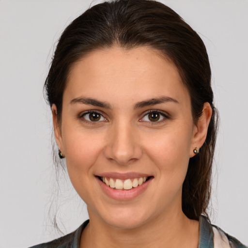 Joyful white young-adult female with medium  brown hair and brown eyes