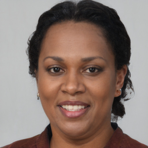 Joyful black adult female with short  brown hair and brown eyes