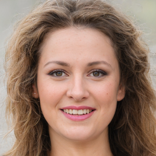 Joyful white young-adult female with long  brown hair and green eyes