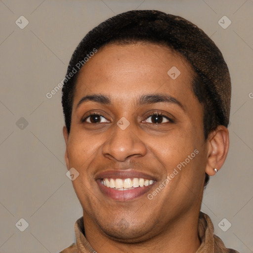 Joyful latino young-adult male with short  black hair and brown eyes