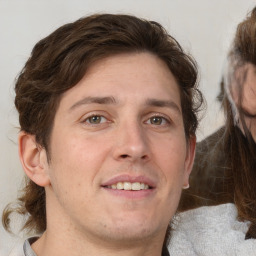 Joyful white adult male with medium  brown hair and brown eyes