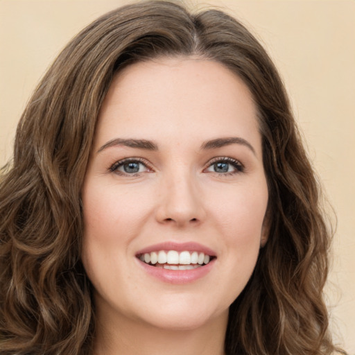 Joyful white young-adult female with long  brown hair and green eyes