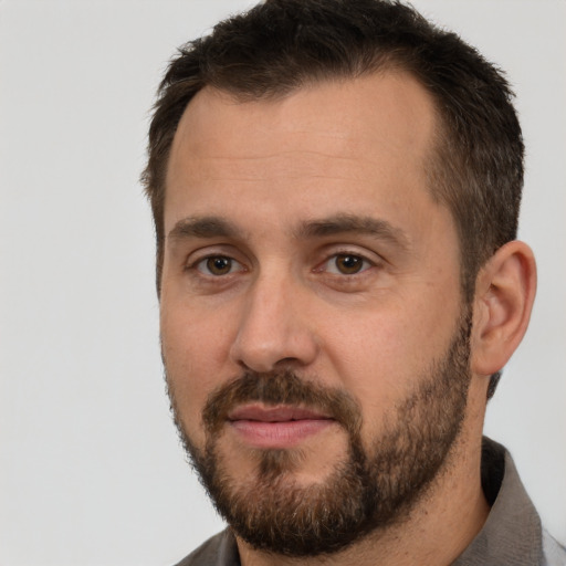 Joyful white adult male with short  brown hair and brown eyes