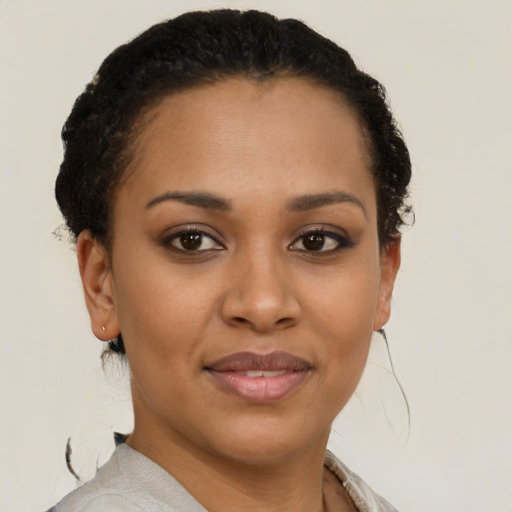 Joyful latino young-adult female with short  brown hair and brown eyes