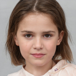 Joyful white child female with medium  brown hair and brown eyes