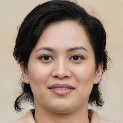 Joyful asian young-adult female with medium  brown hair and brown eyes