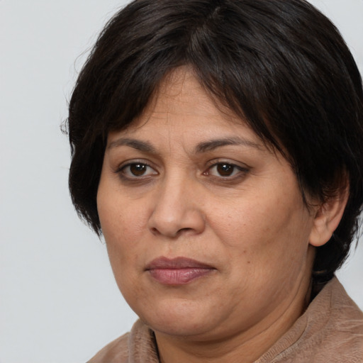 Joyful white adult female with medium  brown hair and brown eyes