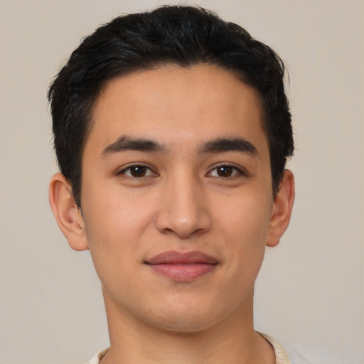 Joyful latino young-adult male with short  brown hair and brown eyes