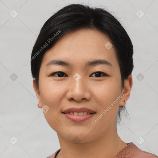 Joyful asian young-adult female with short  black hair and brown eyes