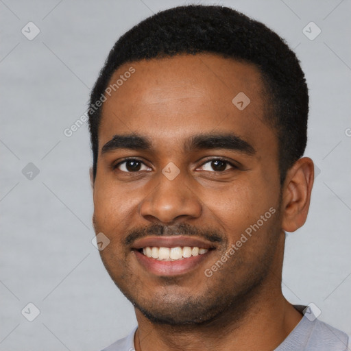 Joyful black young-adult male with short  black hair and brown eyes